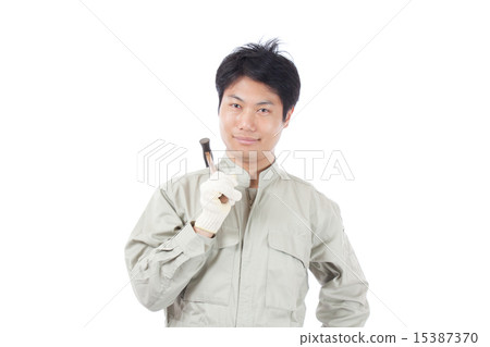 A man with a smile with a hammer / work clothes 15387370