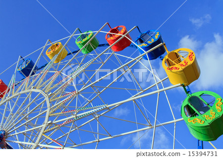 Underside view of a ferris wheel over blue sky Underside view of a ferris wheel over blue sky 15394731