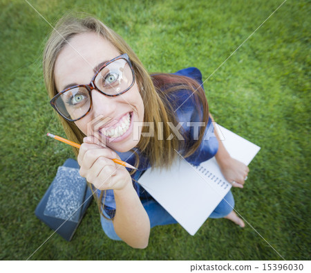 Wide Angle of Young Woman with Books and Pencil 15396030