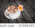 Plumeria flower on wood and glass coffee latte. 15396345