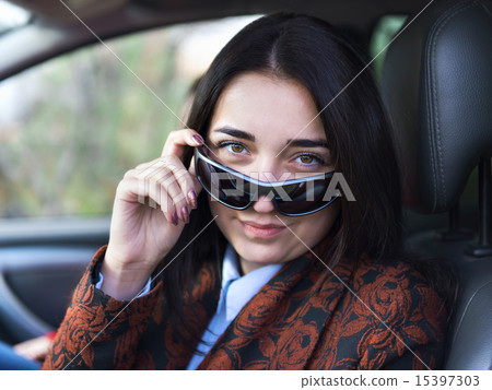 Young pretty  girl sitting behind the wheel of a car 15397303