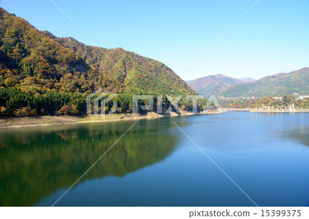 Autumn leaves and lake dam lake Autumn leaves and lake dam lake 15399375