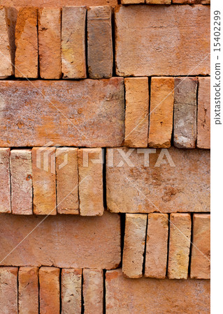 New red brick pavers stacked in rows like wall.  15402299
