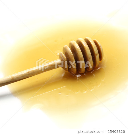 Honey and dipper on white background Honey and dipper on white background 15402820