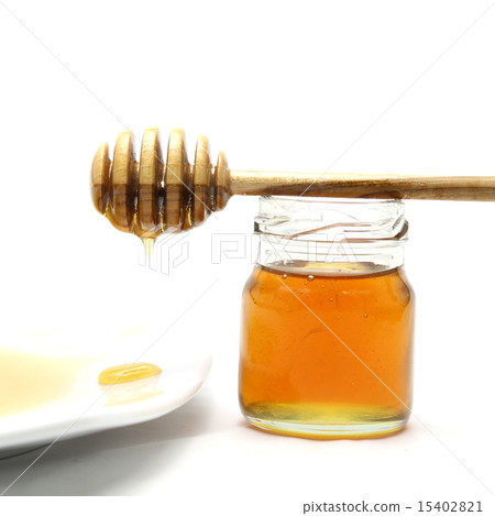 Honey and dipper on white background 15402821