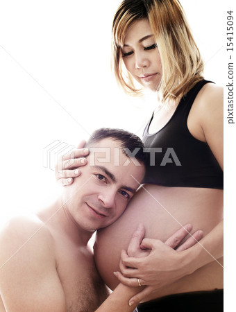 Husband listening the belly of his pregnant asian Husband listening the belly of his pregnant asian 15415094