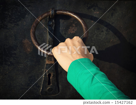 Woman's hand knocking on the door with knocker 15427162
