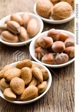 various nuts in ceramic bowls various nuts in ceramic bowls 15428898