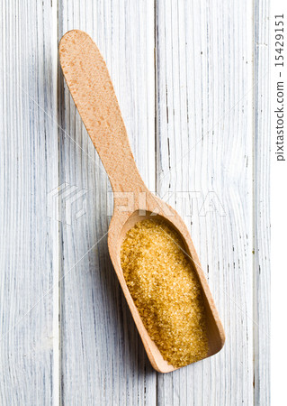 brown sugar in wooden scoop brown sugar in wooden scoop 15429151