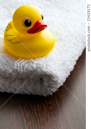 yellow bath duck on white towel yellow bath duck on white towel 15429172