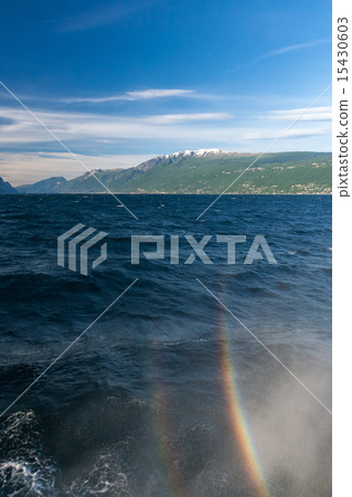 rainbow on a lake Garda with mountains as background rainbow on a lake Garda with mountains as background 15430603