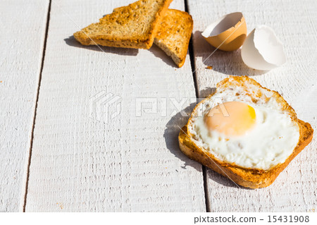 crispy toast with a fried egg and a cup of coffee crispy toast with a fried egg and a cup of coffee 15431908
