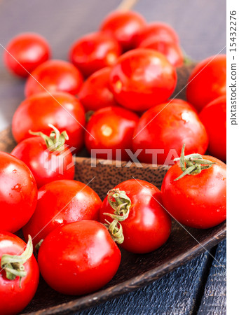 red juicy tomatoes cherry in brown wooden plate red juicy tomatoes cherry in brown wooden plate 15432276