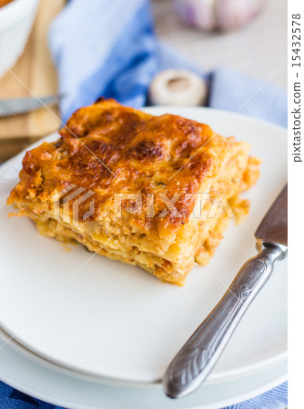 piece of meat lasagna with mushrooms on a plate 15432578