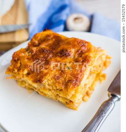 piece of meat lasagna with mushrooms on a plate 15432579