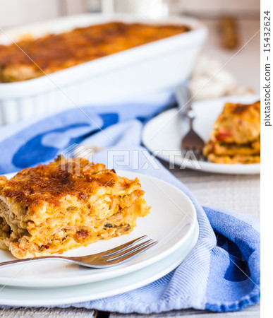 eating a piece of meat lasagna with mushrooms eating a piece of meat lasagna with mushrooms 15432624