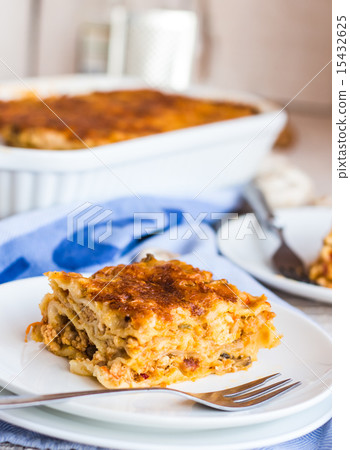 eating a piece of meat lasagna with mushrooms 15432625