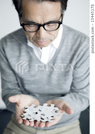 Male in his 70s with puzzle 15445178