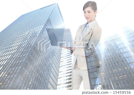 Composite image of confident businesswoman holding laptop 15459556