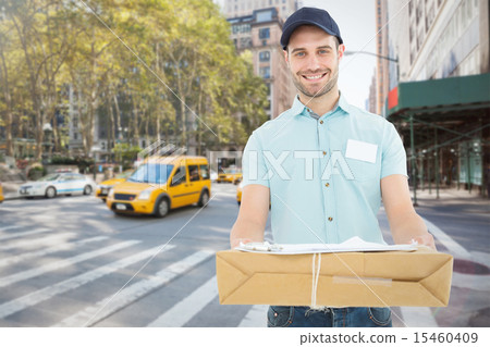 Composite image of handsome courier man with parcel 15460409