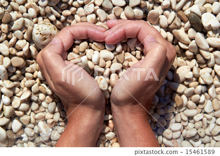 Hands in the form of heart with pebbles inside Hands in the form of heart with pebbles inside 15461589