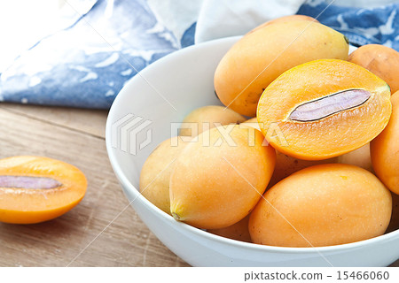 Sweet Marian plum fruit in bowl on wooden Sweet Marian plum fruit in bowl on wooden 15466060