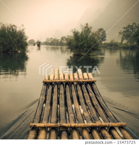 China Guilin Yangshuo bamboo rafting in the beautiful "Yulong River" retro colors. 15473725