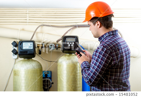 inspector typing meter reading on smartphone inspector typing meter reading on smartphone 15481052