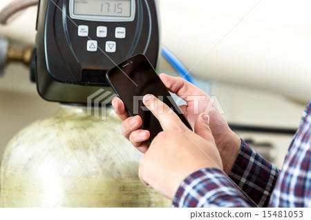 man typing factory equipment meter reading at smartphone 15481053