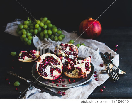 Red ripe peeled pomegranate on rustic metal plate Red ripe peeled pomegranate on rustic metal plate 15484040