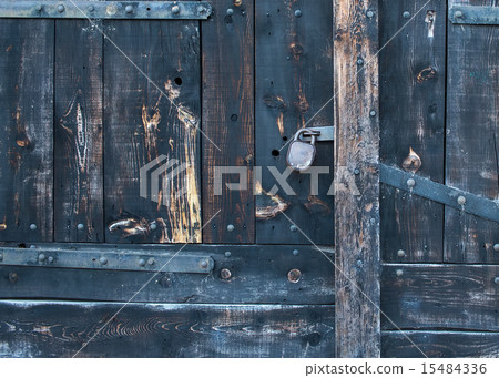 Old rustic faded wood gate with a lock 15484336