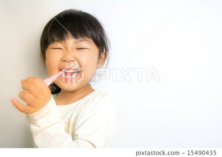 A girl brushing with a smile A girl brushing with a smile 15490435