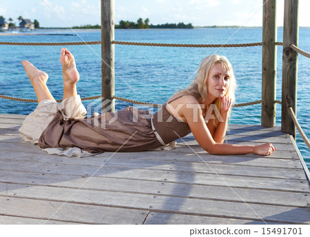 beautiful woman on a wooden scaffold over the sea. 15491701