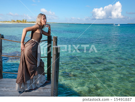 beautiful woman on a wooden scaffold over the sea 15491887