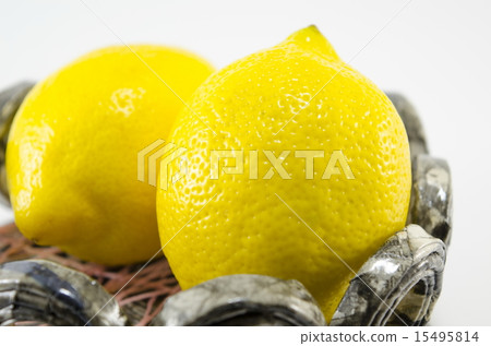 Two lemons in decorated bowl 15495814