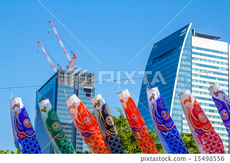 Carp streamers and skyscrapers under construction 15498556