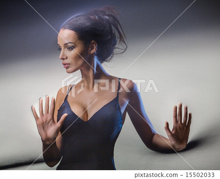 Graceful brunette stretches stretch mesh fabric in front of you  15502033