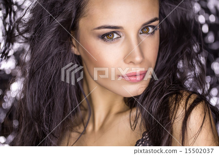 Close portrait of attractive brunette in the studio. Creative us 15502037