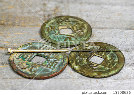 acupuncture needle on antique chinese coin acupuncture needle on antique chinese coin 15508626