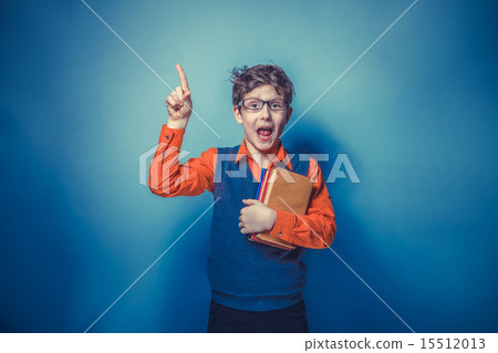 European-looking  boy of ten years in glasses thumbs up, the ide 15512013