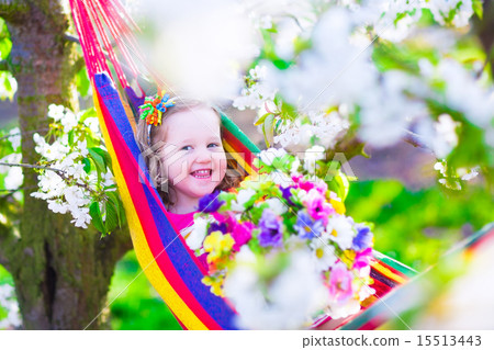 Little girl relaxing in a hammock Little girl relaxing in a hammock 15513443