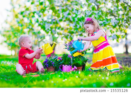 Kids in a garden with blooming cherry trees 15535126