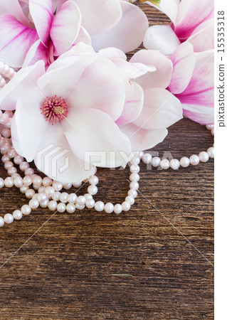 magnolia flowers with pearls on wooden table magnolia flowers with pearls on wooden table 15535318