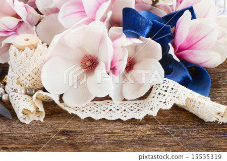 magnolia flowers with pearls on wooden table magnolia flowers with pearls on wooden table 15535319