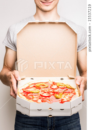 Young man offers pizza diabola. Young man offers pizza diabola. 15537219