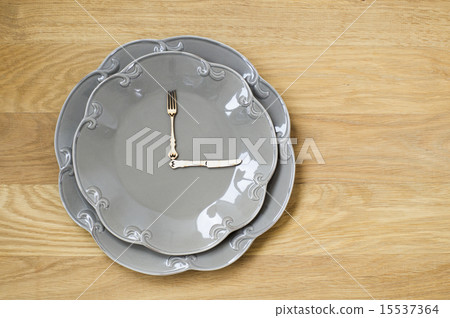 Grey plate clock on a wooden background 15537364