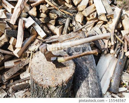 pile of wood, deck for chopping firewood, two axes 15548567