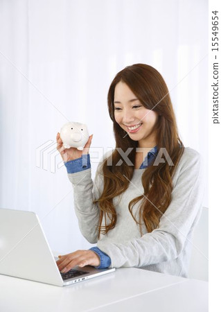 A woman with a piggy bank A woman with a piggy bank 15549654