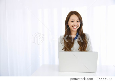 Young woman using a personal computer Young woman using a personal computer 15553928