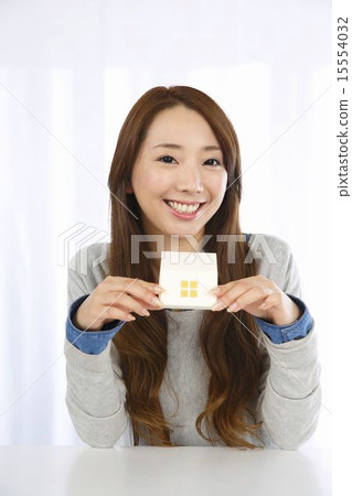 A young lady with a house model 15554032